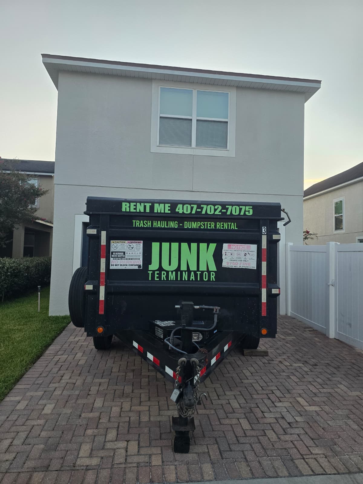 Dumpster placed in front of a residential home